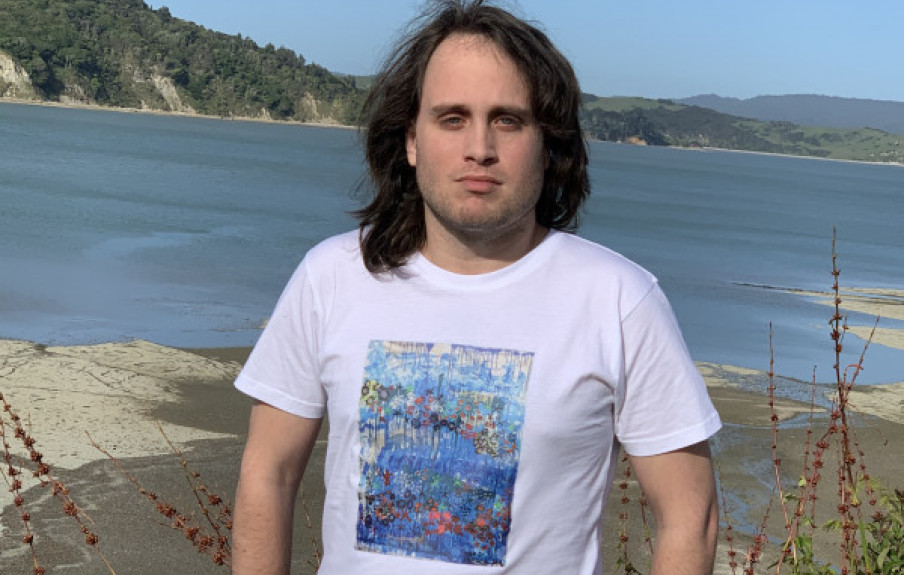 Yaniv on Raglan Beach modelling one of his Touch the World t-shirts, the result of a collaboration with Famine of Beauty t-shirts.