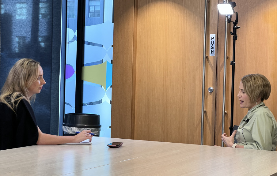 Anna Whyte is interviewing Paula Tesoriero. They sitting opposite each other at the end of a table.